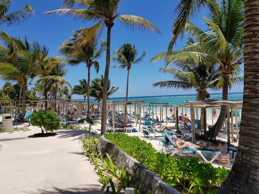 Beach beds, white sand and turquoise waters at the Akumal Bay Beach