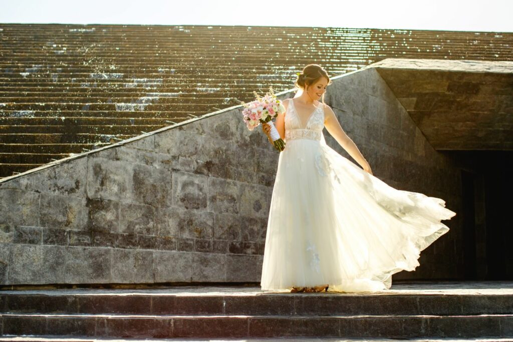 a beautiful bride enjoying a view of her wedding dress