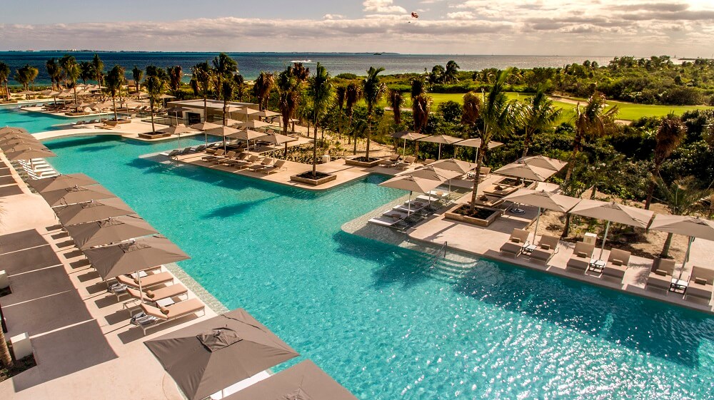 main pool area and golf course in the background atelier playa mujeres