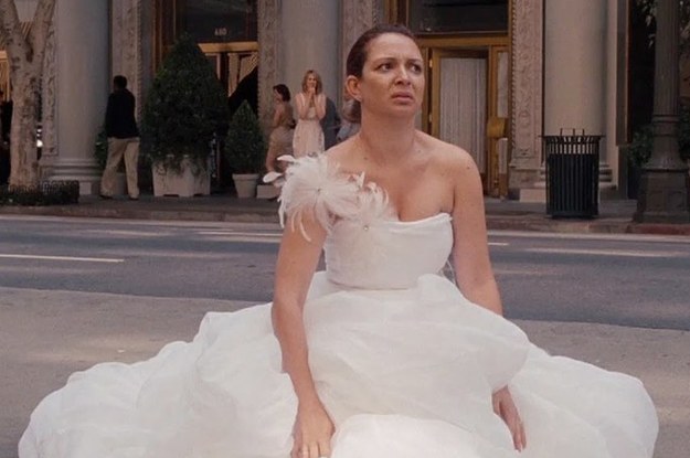 Bride in gown sitting on the street