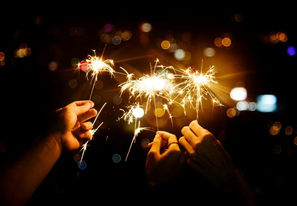 people celebrating with sparklers