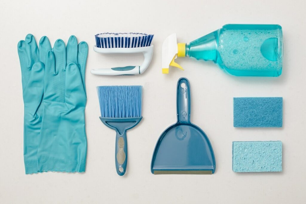 blue cleaning products including gloves, sponges, spray and brushes