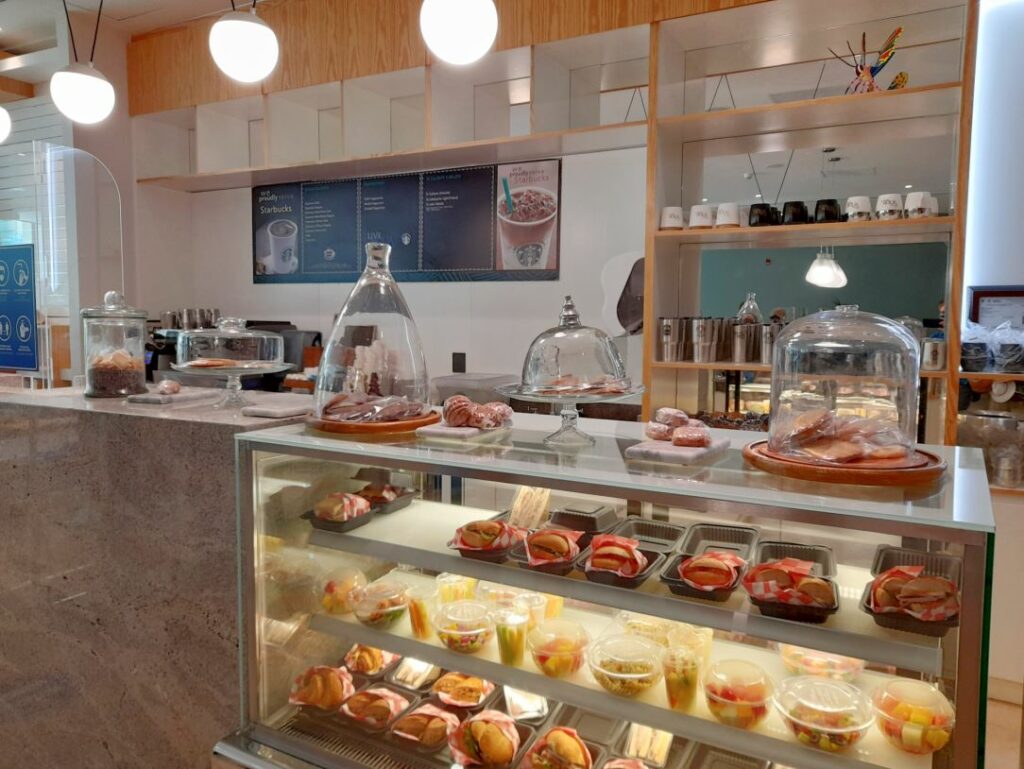 Pastries, paninis and bread in a refrigerator