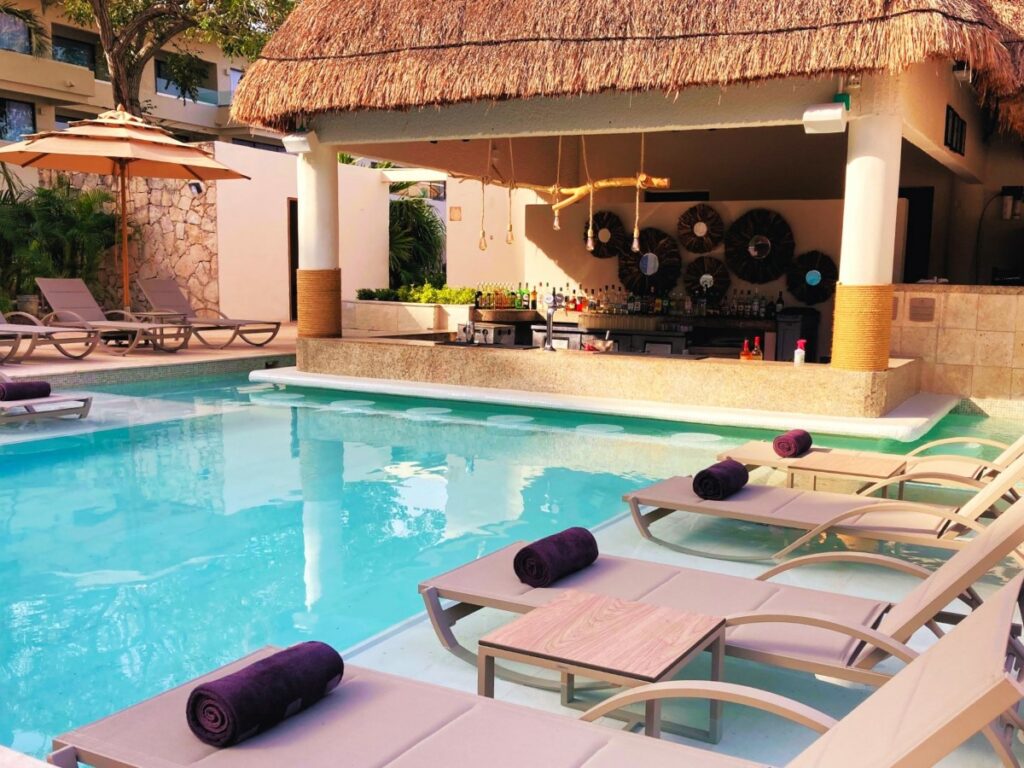 Swim up bar with loungers at a beach resort in the riviera maya