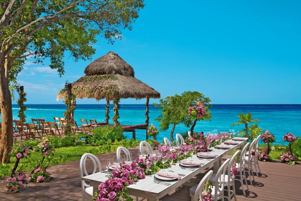 - Wedding set up with gazebo and a reception table with pink roses