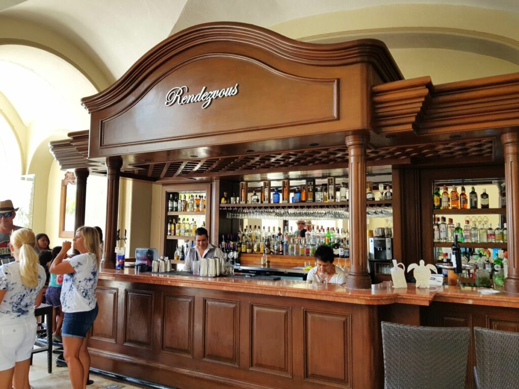 Classic lobby bar made of wood with mirrors and lots of wine and liquor bottles