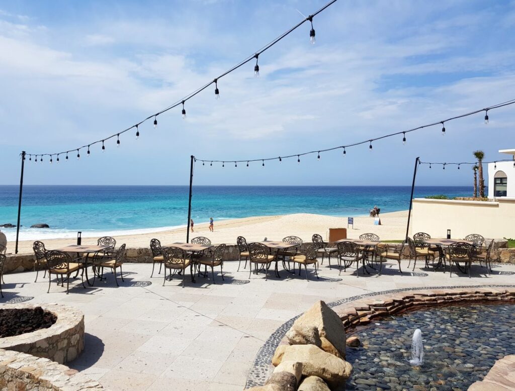 Hotel beach side terrace with ironworks furniture and string lights