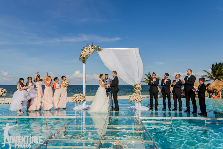 Destination wedding ceremony set-up Over the water at the infinity pool location of the Dreams Natura Riviera Cancun