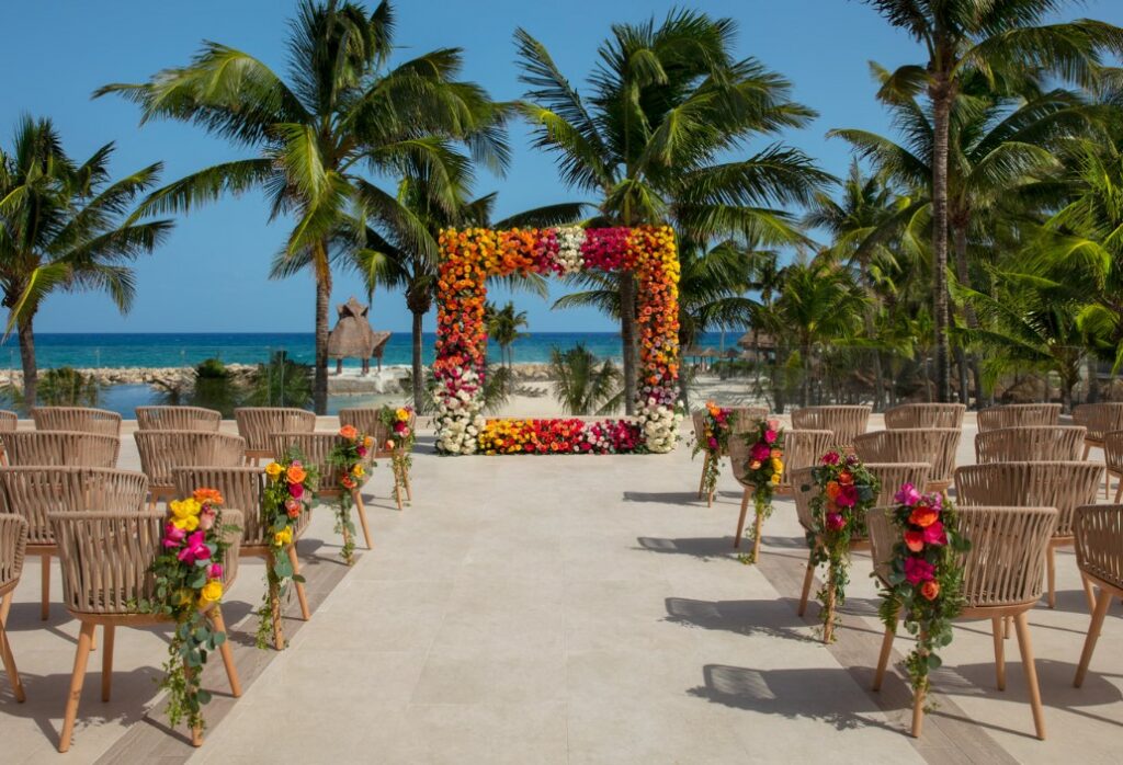 Ocean view rooftop wedding set up with a square gazebo with flowers