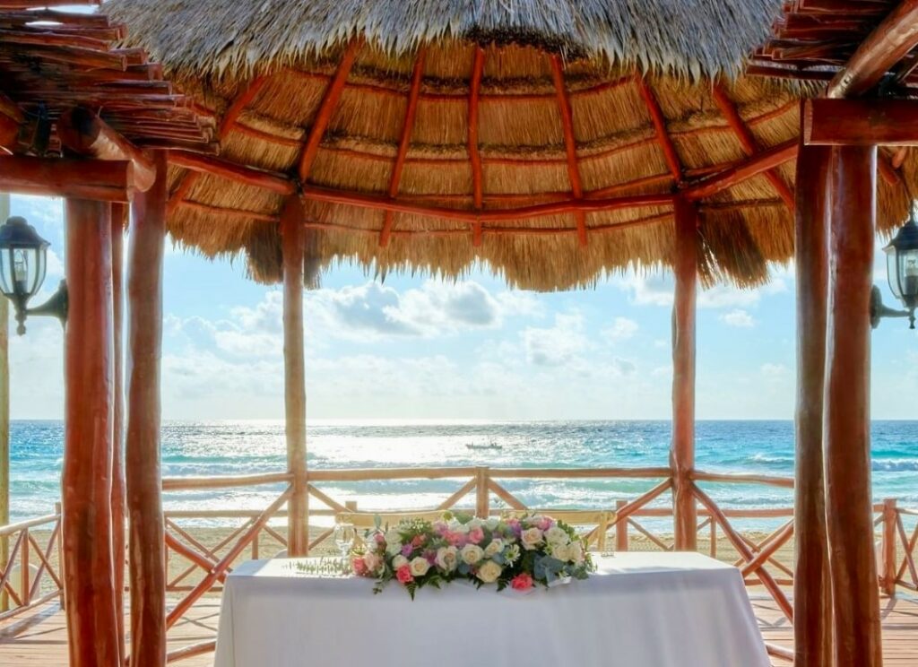 wedding set up in a palapa with ocean view