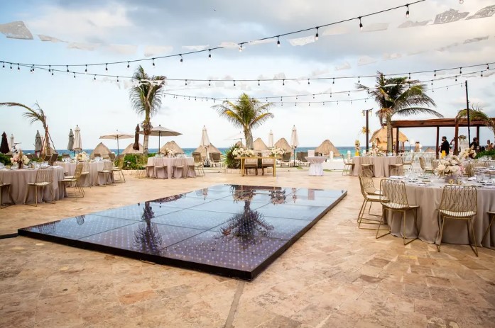 Outdoor wedding reception with string lights on the top