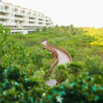 A bridge crossing through a resort garden