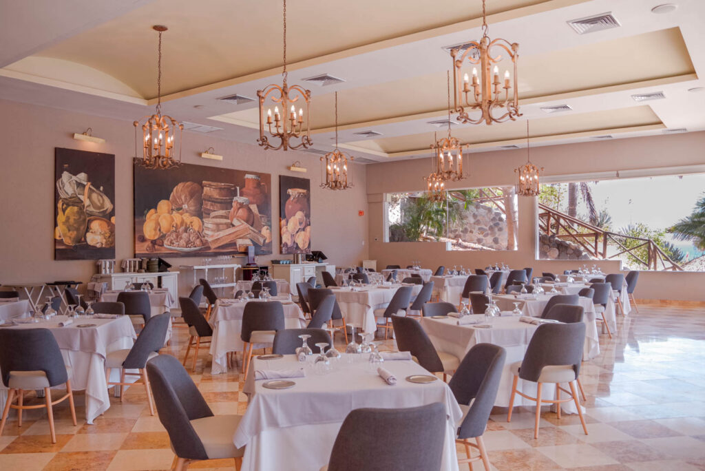 Italian restaurant with hanging lanterns, large windows and a still life painting