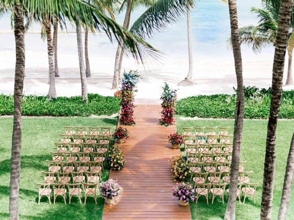 A beautiful wedding ceremony on a beach front garden with colorful flowers