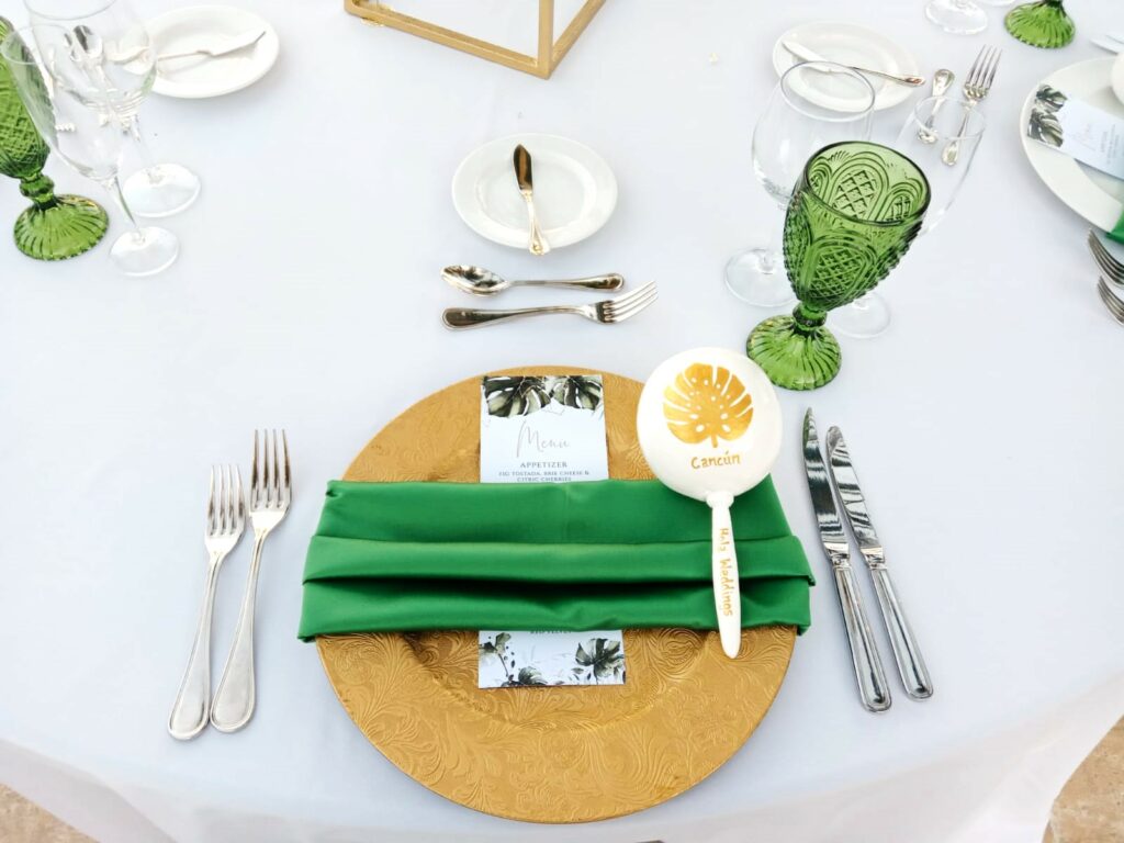 a wedding set up in gold and green with an hola weddings maraca