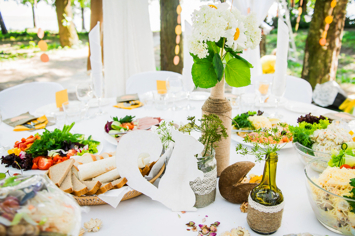 Pic of a nice picnic table with flowers and breads