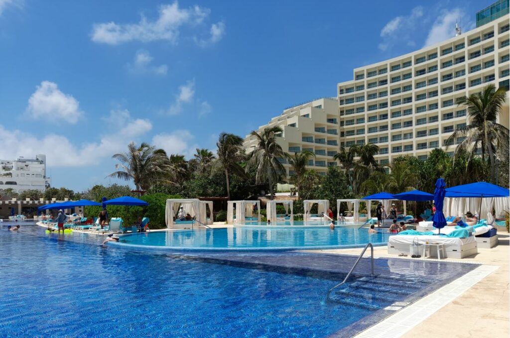 Pools and cabanas with blue umbrellas