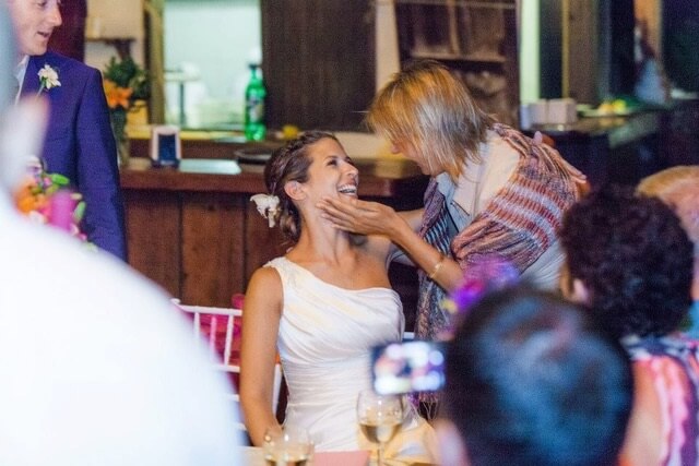 wedding planner cradling bride's face with affection