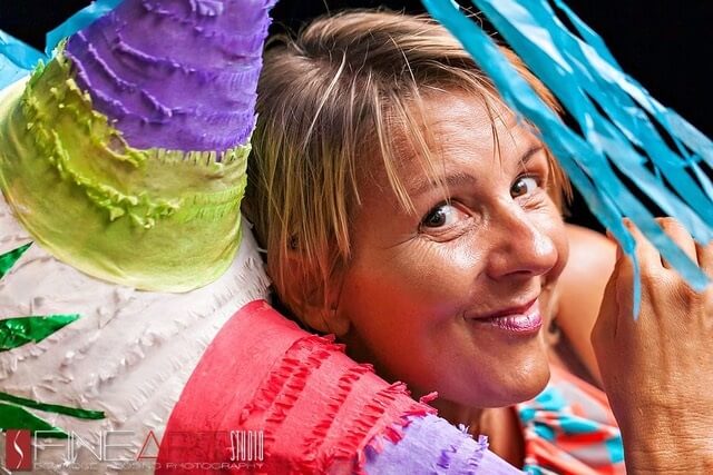 pro tips from a destination wedding planner, maria tripaldi headshot with colorful pi&ntilde;ata