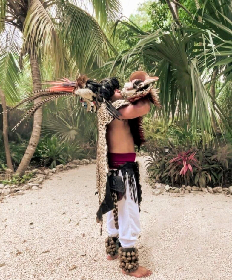 a mayan man performing a ceremony in the jungle