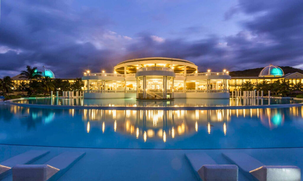 Resort pool picture with the lights on taken at night