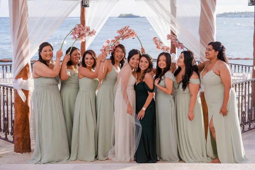wedding party with flowers and ocean view gazebo