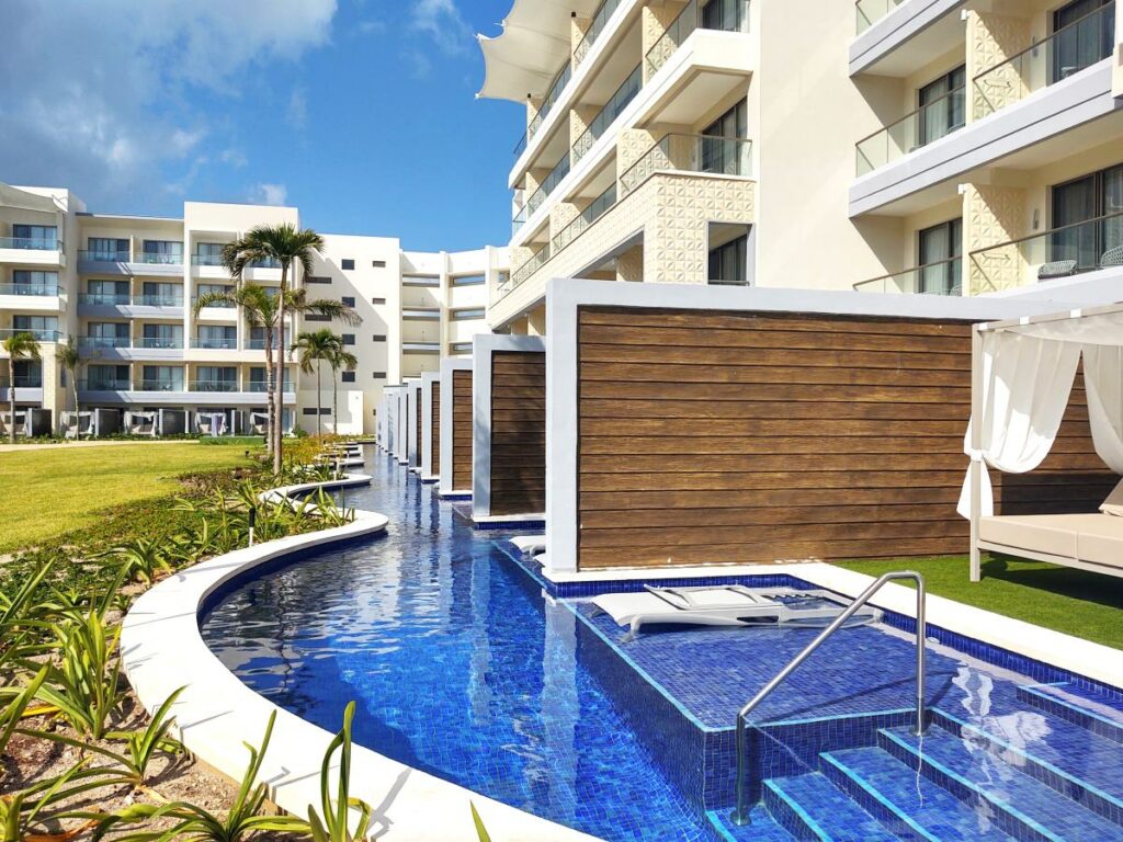 view of a swim up room area with loungers, gardens and a bali bed