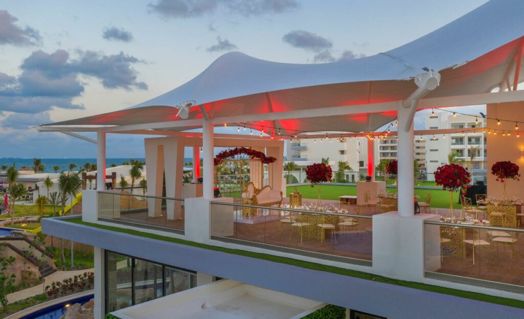 wedding ceremony set up on a rooftop of a beach resort in cancun
