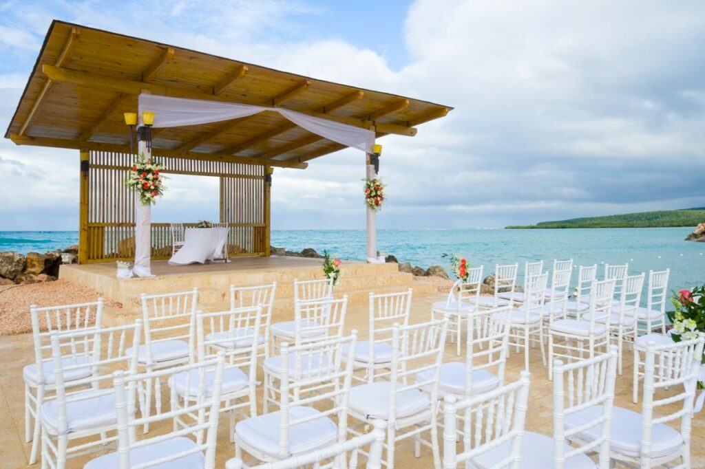 oceanfront beach wedding area with a palapa roof and ocean view