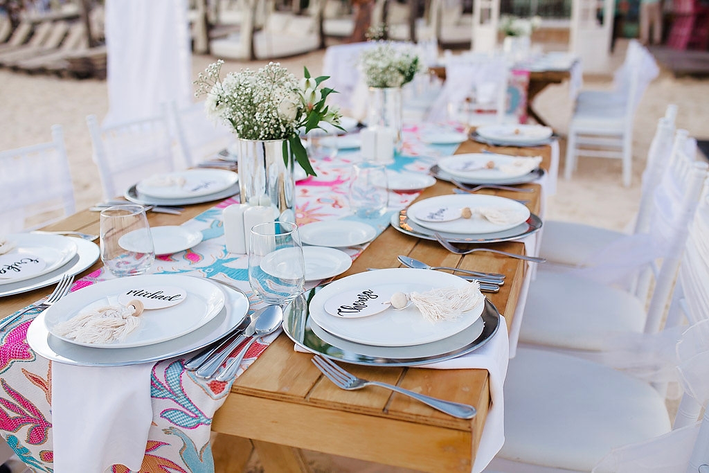 resort restaurant with buffet bar on the side and wood arm chairs and chandeliers