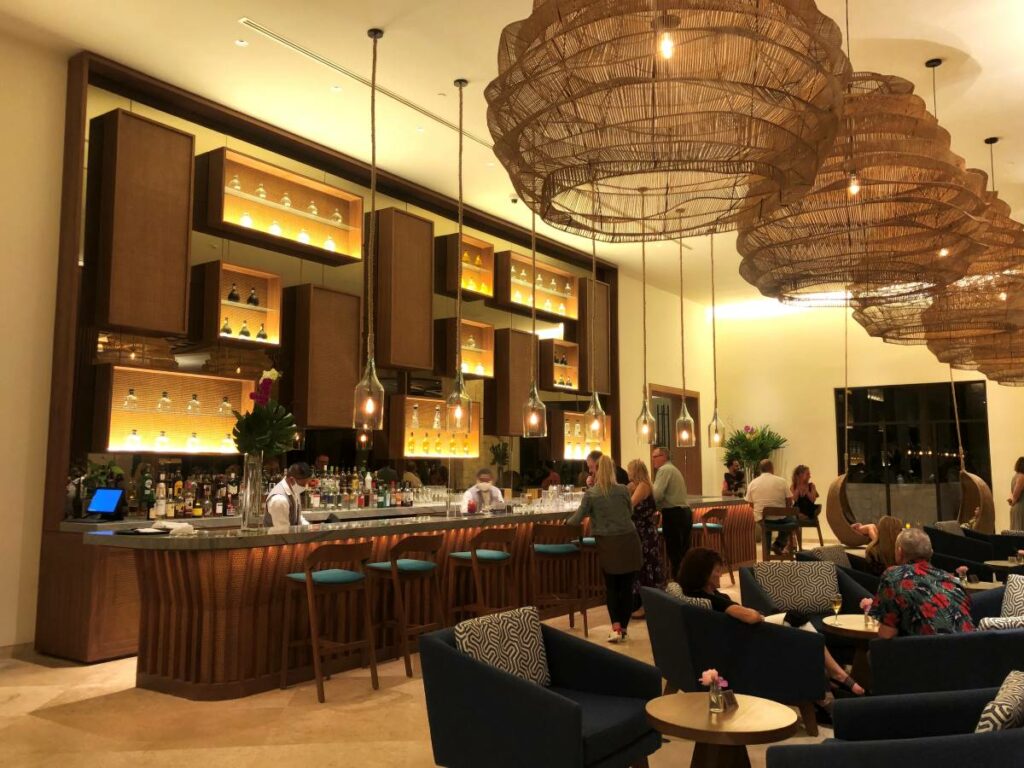 Elegant Lobby bar with wooden lamps, blue chairs and hagning lanterns