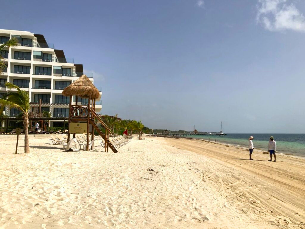 Extensive beach area with a palapa