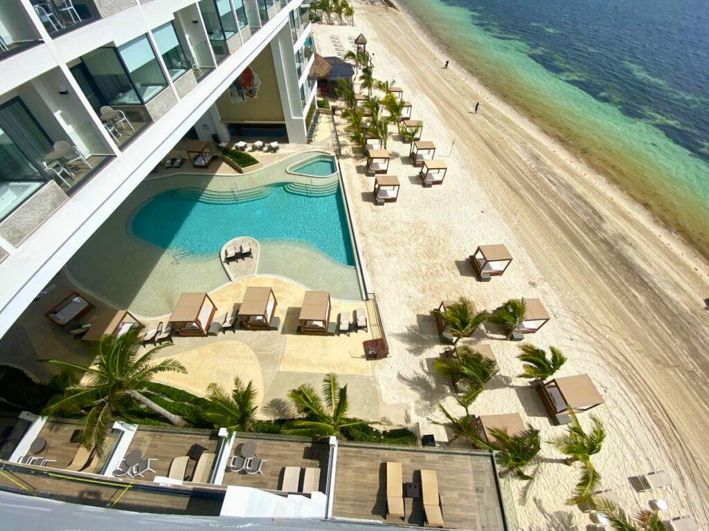 Aerial view of a beach resort in Cancun with pools and bali beds