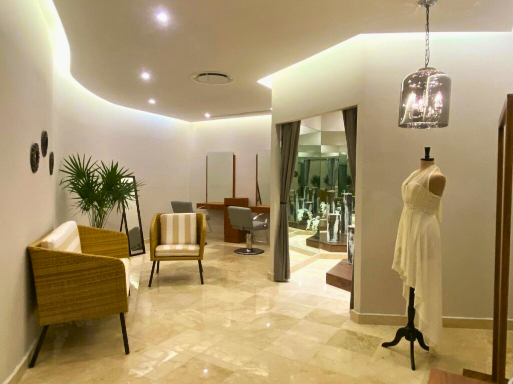 Bridal suite with large mirrors and loung chairs and a wedding dress