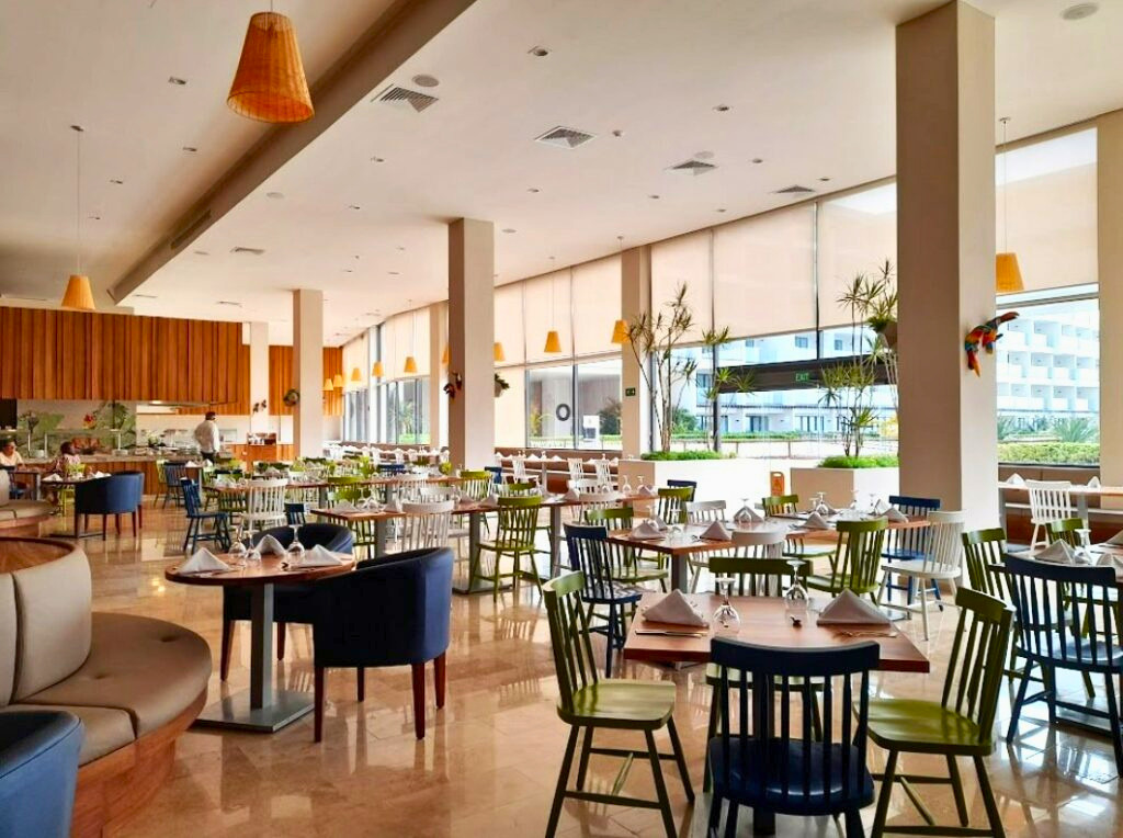 Hotel restaurant with large windows and colorful furniture