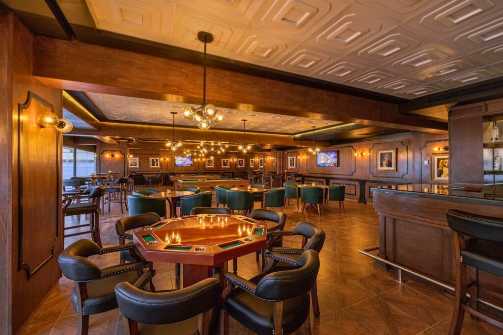 Dark wooden bar with poker tables and leather furniture