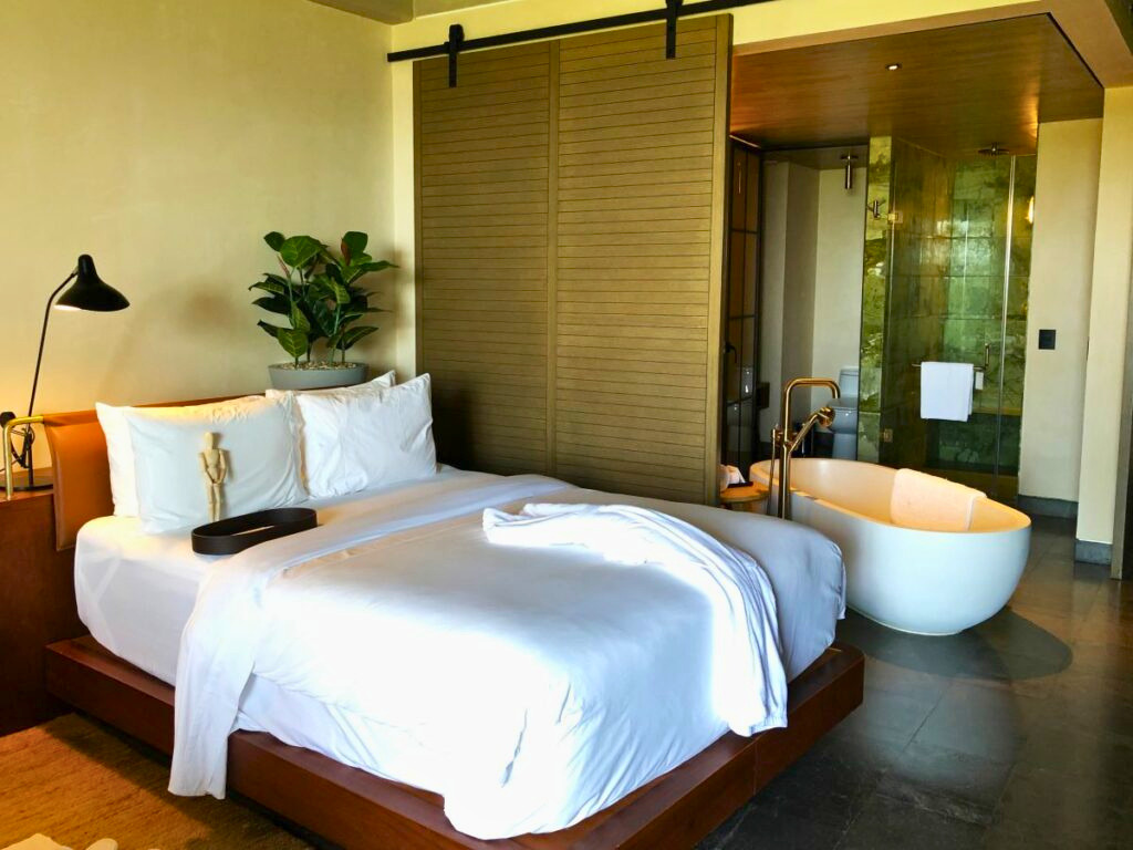 Resort suite with a king size bed and a bath tub
