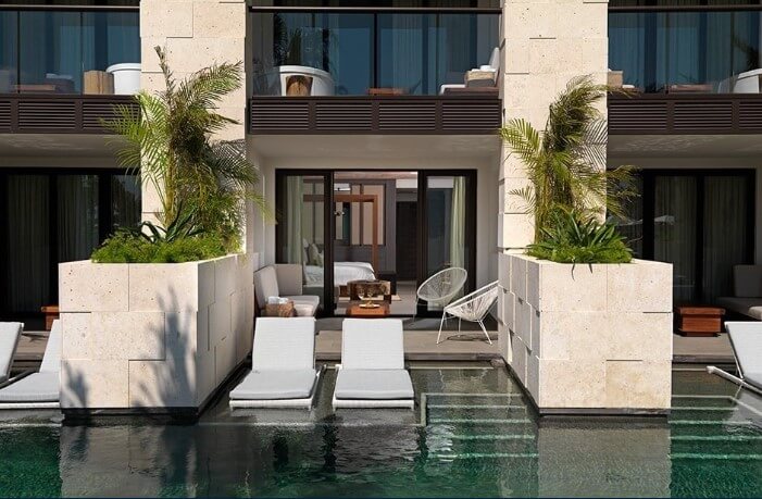 hotel room exterior, swim up room with loungers and patio area at unico hotel