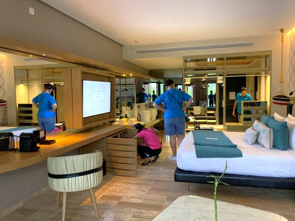 Hola Weddings team inspecting a hotel room