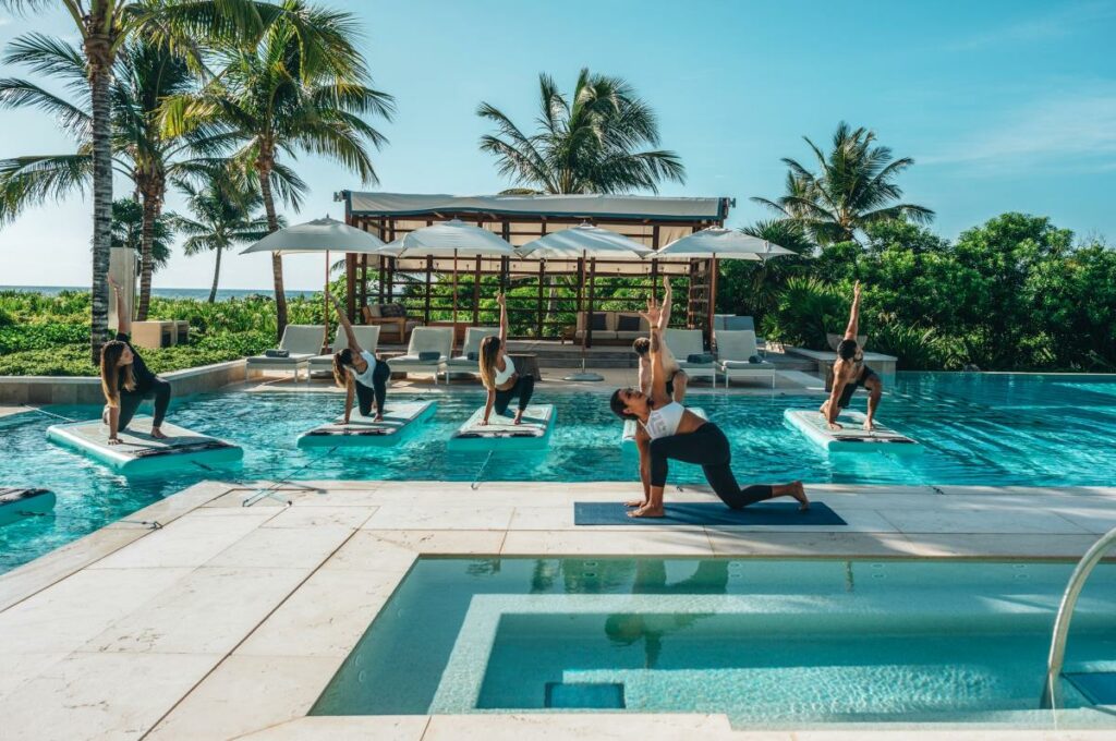 stand up paddel yoga lesson at the pool of unico riviera maya hotel