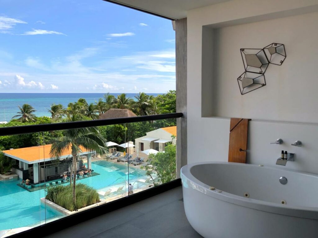 Hotel room balcony with ocean view and a large bathtub