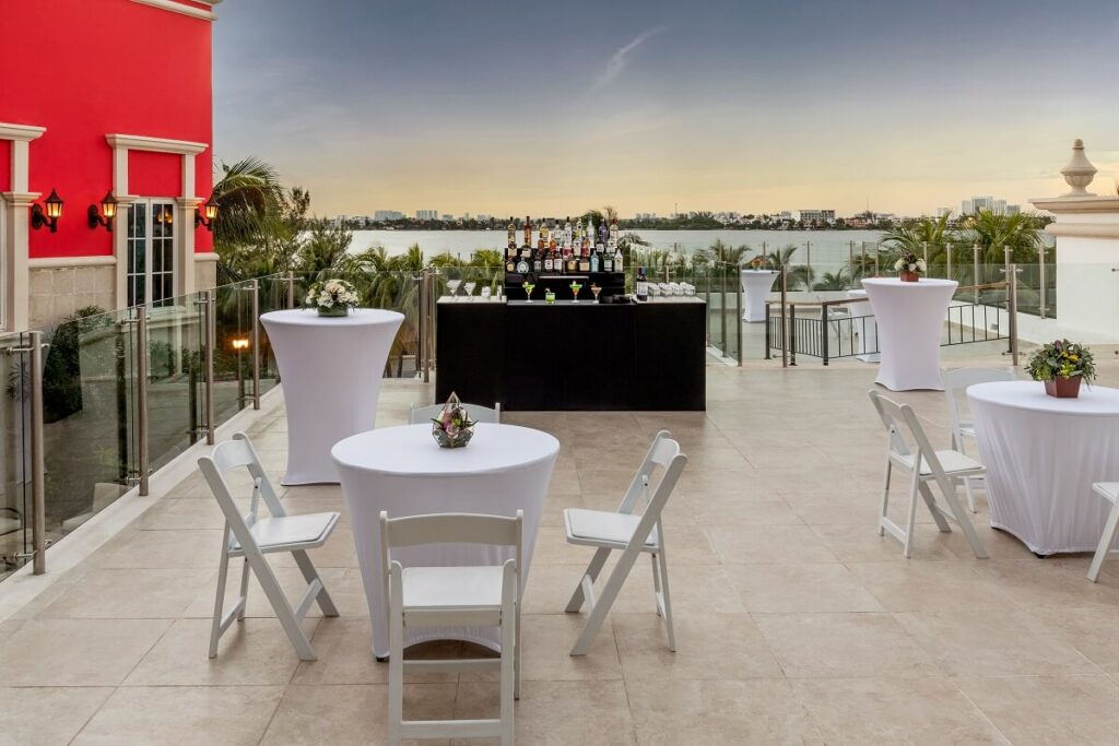 wedding cocktail hour in a terrace with ocean view during sunset