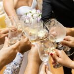 couple toasting with guests on their wedding day