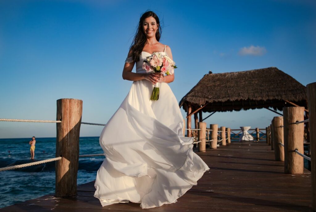 a beautiful bride posing with her wedding dress
