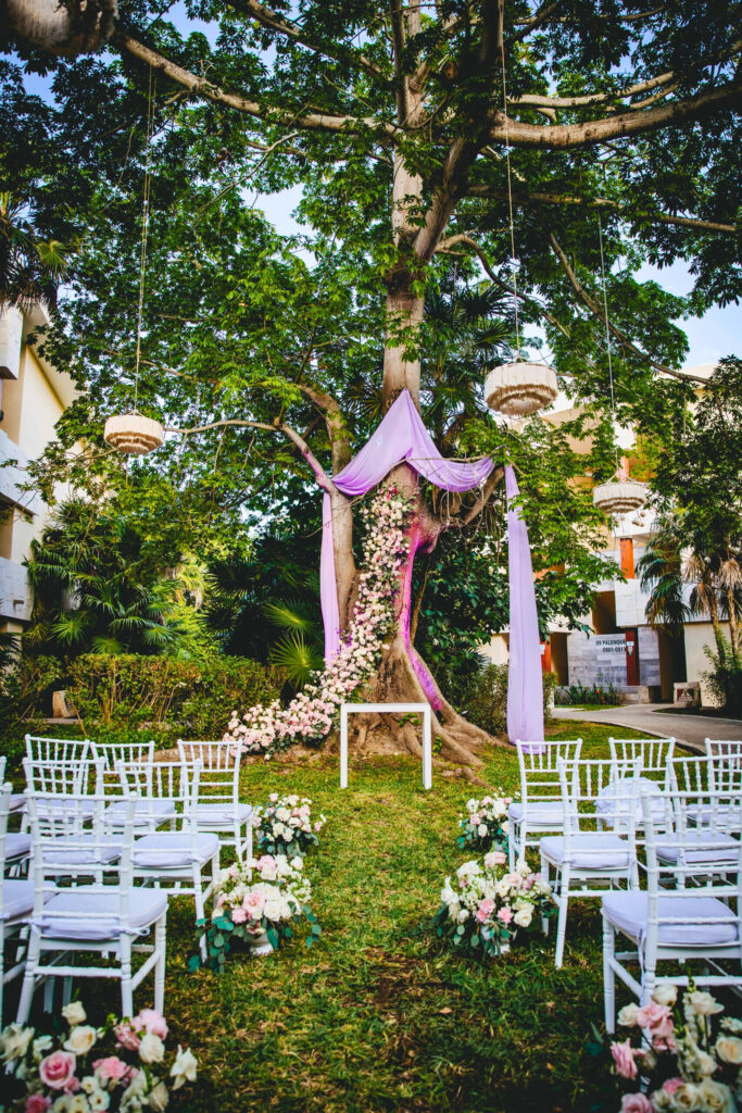 Yaxche garden wedding ceremony with ping drapes and colorful flowers
