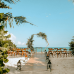 beach wedding ceremony set up with an hexagon with flowers