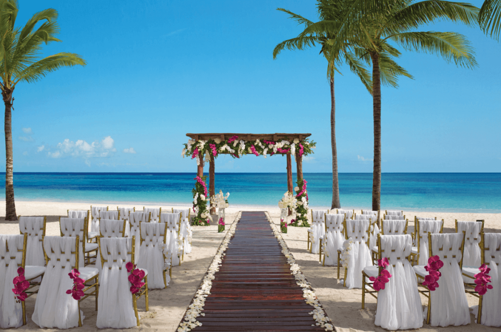 Beach gazebo set up for a destination wedding at Secrets Akumal with pink flowers and golden chairs