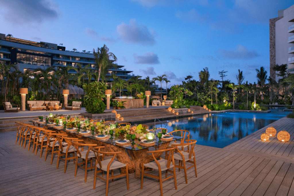 outdoor dinner set up by the pool during sunset