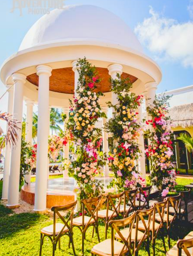 White wedding gazebo set up in a resort garden for a ceremony